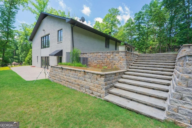 9701 Buice Rd, Alpharetta, GA 30022 - view of home's exterior with a patio area, a lawn, and cooling unit