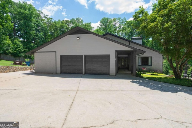 9701 Buice Rd, Alpharetta, GA 30022 - ranch-style house featuring a chimney, an attached garage, and driveway