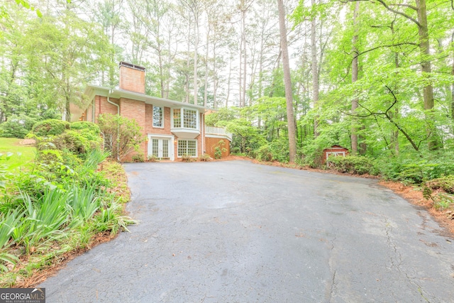 302 Brookwood Ln, Lafayette, GA 30728 - view of side of home featuring a chimney, french doors, brick siding, and driveway
