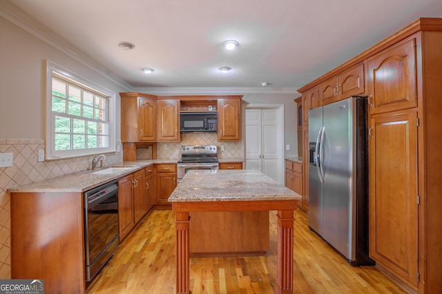 302 Brookwood Ln, Lafayette, GA 30728 - kitchen with black appliances, a sink, a kitchen island, light wood-style flooring, and ornamental molding