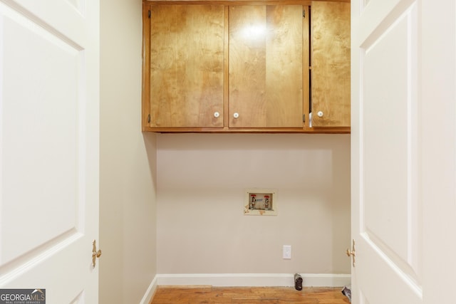 302 Brookwood Ln, Lafayette, GA 30728 - laundry room with hookup for a washing machine, cabinet space, light wood-style flooring, and baseboards