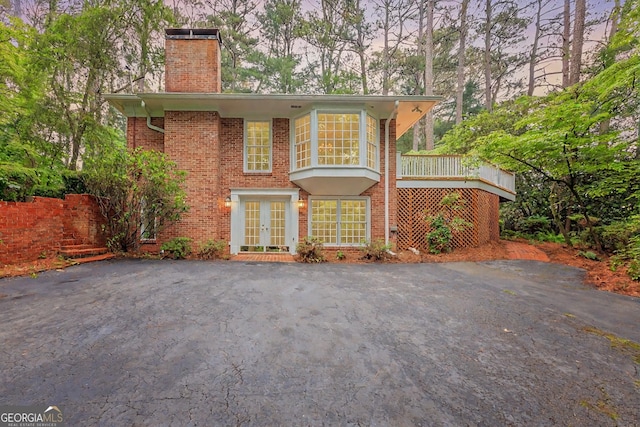 302 Brookwood Ln, Lafayette, GA 30728 - view of front of house featuring french doors, a chimney, and brick siding