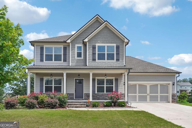 1824 Alberta Ln, Winder, GA 30680 - craftsman house featuring concrete driveway, an attached garage, a front lawn, and a porch