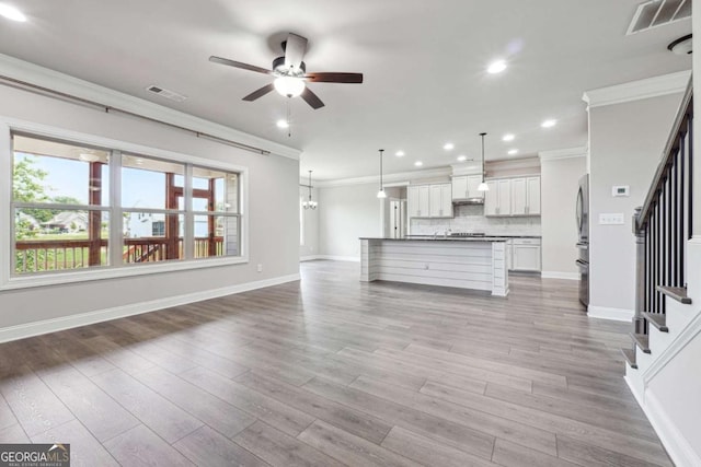 1824 Alberta Ln, Winder, GA 30680 - unfurnished living room featuring crown molding, ceiling fan, stairway, recessed lighting, and baseboards