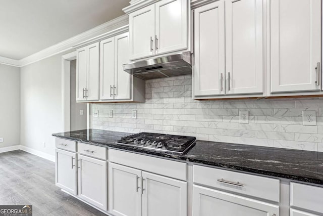 1824 Alberta Ln, Winder, GA 30680 - kitchen featuring under cabinet range hood, stainless steel gas stovetop, baseboards, backsplash, and ornamental molding