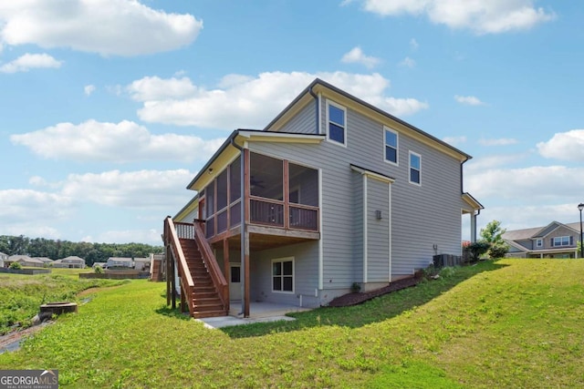 1824 Alberta Ln, Winder, GA 30680 - back of property with a sunroom, stairs, a lawn, a patio, and central air condition unit
