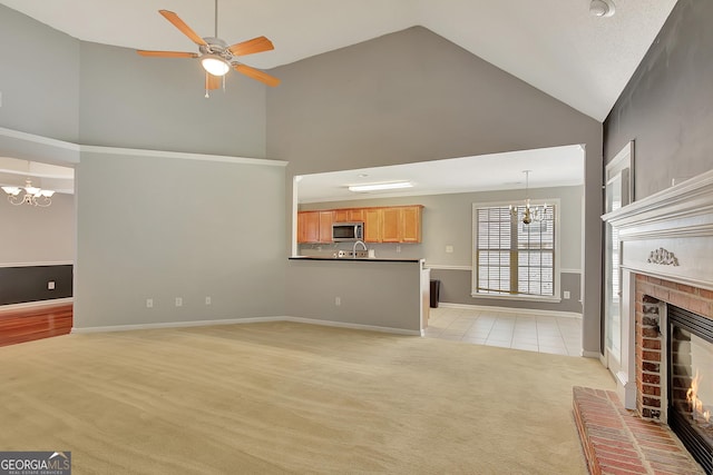 85 Parks Pl, Sharpsburg, GA 30277 - unfurnished living room with a chandelier, light colored carpet, high vaulted ceiling, a fireplace, and a ceiling fan