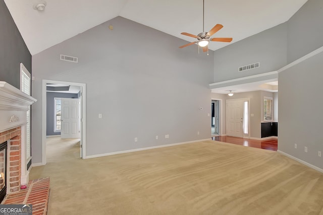 85 Parks Pl, Sharpsburg, GA 30277 - unfurnished living room featuring high vaulted ceiling, a ceiling fan, light carpet, a fireplace, and baseboards