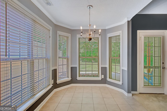 85 Parks Pl, Sharpsburg, GA 30277 - unfurnished dining area featuring a chandelier, healthy amount of natural light, a textured ceiling, and crown molding