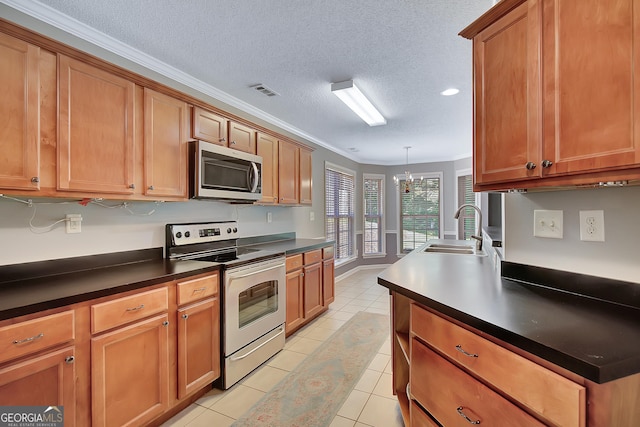 85 Parks Pl, Sharpsburg, GA 30277 - kitchen with appliances with stainless steel finishes, a sink, crown molding, dark countertops, and brown cabinets