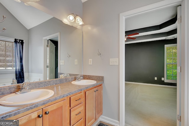 85 Parks Pl, Sharpsburg, GA 30277 - full bathroom with ceiling fan, double vanity, vaulted ceiling, and baseboards