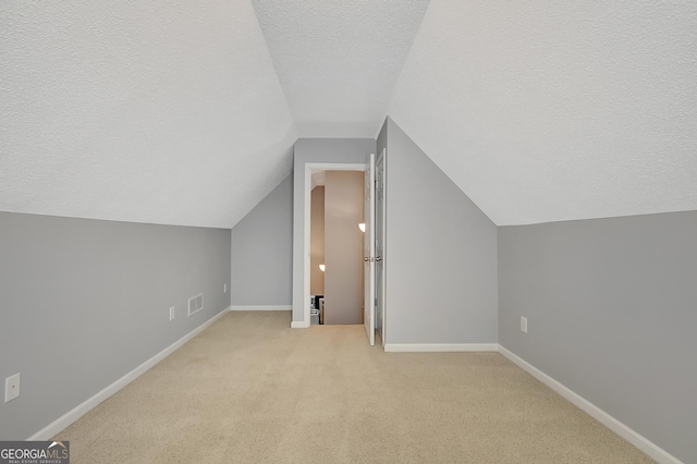 85 Parks Pl, Sharpsburg, GA 30277 - bonus room with a textured ceiling, vaulted ceiling, baseboards, and carpet flooring