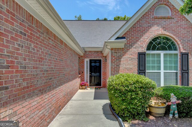 85 Parks Pl, Sharpsburg, GA 30277 - doorway to property featuring roof with shingles and brick siding