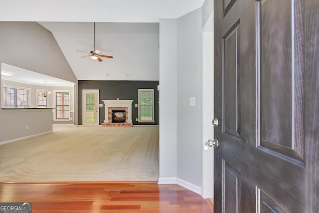 85 Parks Pl, Sharpsburg, GA 30277 - entrance foyer featuring baseboards, ceiling fan, a fireplace, wood finished floors, and high vaulted ceiling