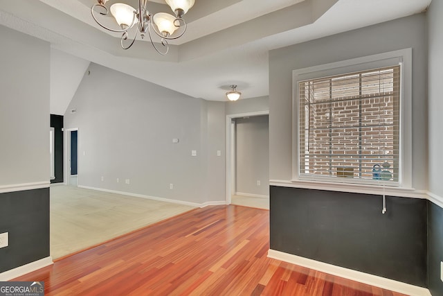 85 Parks Pl, Sharpsburg, GA 30277 - unfurnished living room with a chandelier, light wood-type flooring, and plenty of natural light