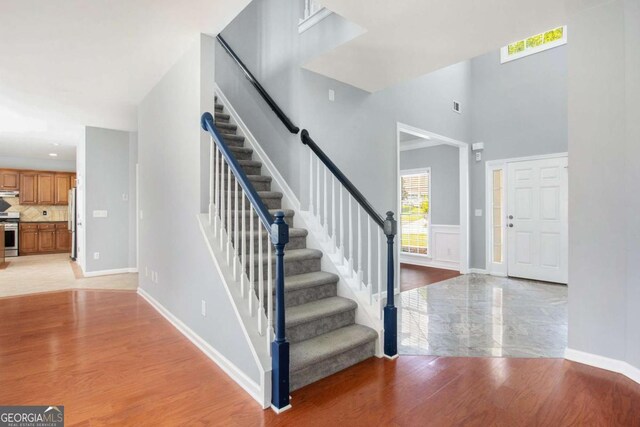 2023 Arbor Springs Way, Buford, GA 30519 - staircase with wood finished floors and a high ceiling