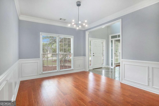2023 Arbor Springs Way, Buford, GA 30519 - unfurnished dining area with a chandelier, a decorative wall, ornamental molding, wainscoting, and wood finished floors