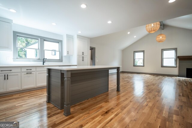 215 Holman Ave, Athens, GA 30606 - kitchen featuring healthy amount of natural light, white cabinets, light countertops, lofted ceiling, and recessed lighting