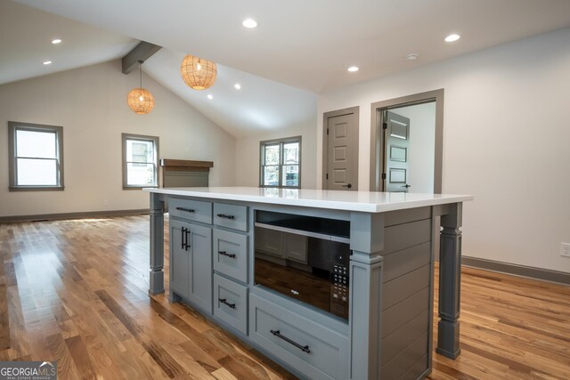 215 Holman Ave, Athens, GA 30606 - kitchen with a breakfast bar, gray cabinets, light wood-style flooring, light countertops, and recessed lighting