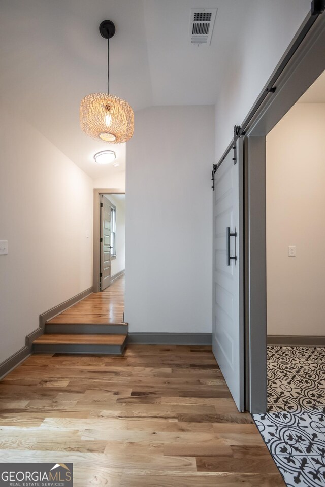 215 Holman Ave, Athens, GA 30606 - hall with a barn door, wood finished floors, and baseboards