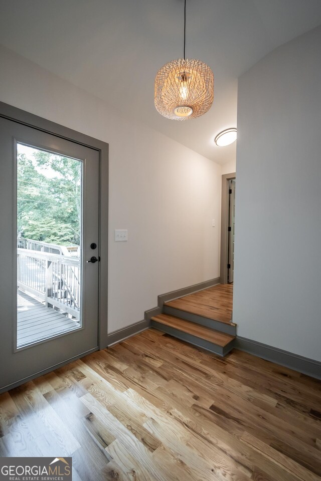 215 Holman Ave, Athens, GA 30606 - doorway to outside with wood finished floors, a chandelier, and baseboards