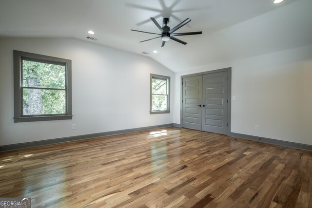 215 Holman Ave, Athens, GA 30606 - unfurnished bedroom featuring lofted ceiling, recessed lighting, wood finished floors, a closet, and baseboards