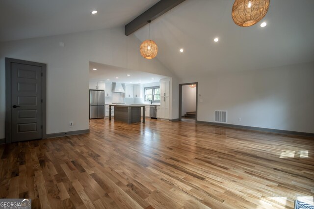 215 Holman Ave, Athens, GA 30606 - unfurnished living room featuring wood finished floors, beamed ceiling, high vaulted ceiling, recessed lighting, and baseboards