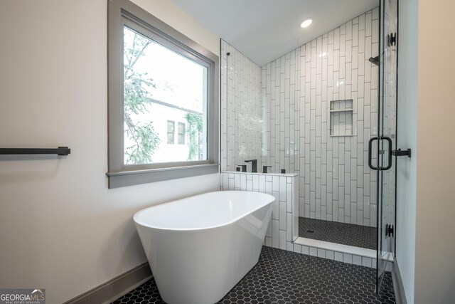 215 Holman Ave, Athens, GA 30606 - full bathroom featuring baseboards, a stall shower, a freestanding tub, healthy amount of natural light, and recessed lighting