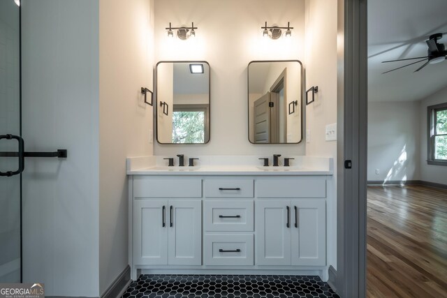 215 Holman Ave, Athens, GA 30606 - bathroom with baseboards, double vanity, wood finished floors, and a ceiling fan