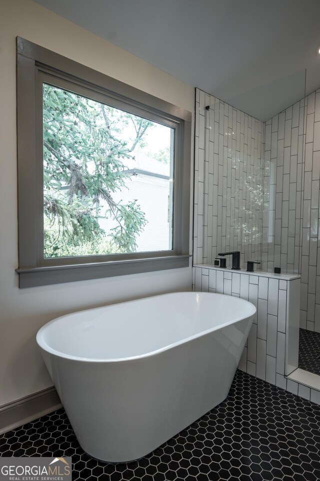215 Holman Ave, Athens, GA 30606 - bathroom with a soaking tub, a walk in shower, tile patterned flooring, and baseboards