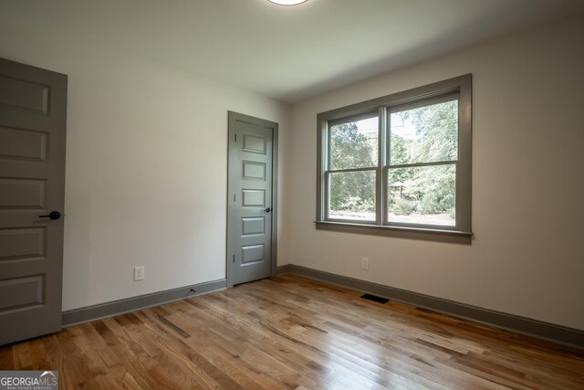215 Holman Ave, Athens, GA 30606 - empty room with wood finished floors and baseboards