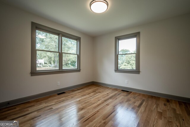 215 Holman Ave, Athens, GA 30606 - spare room with healthy amount of natural light, wood finished floors, and baseboards