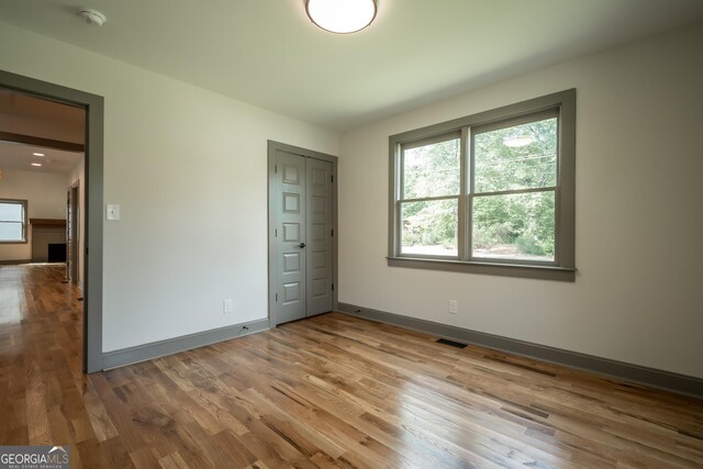 215 Holman Ave, Athens, GA 30606 - unfurnished bedroom with wood finished floors and baseboards