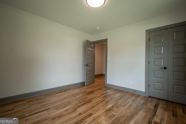 215 Holman Ave, Athens, GA 30606 - unfurnished bedroom with light wood finished floors and baseboards