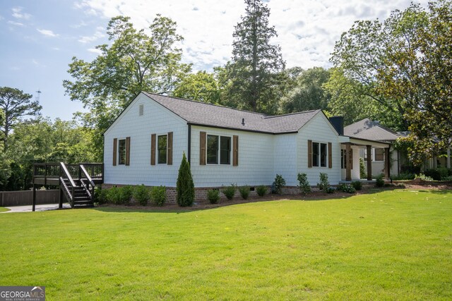 215 Holman Ave, Athens, GA 30606 - view of front of home with stairs, a wooden deck, a front yard, and a shingled roof