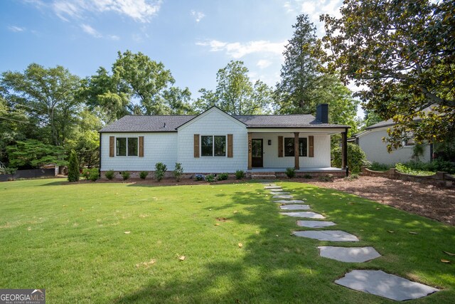215 Holman Ave, Athens, GA 30606 - ranch-style house featuring a porch, a chimney, a front yard, and a shingled roof