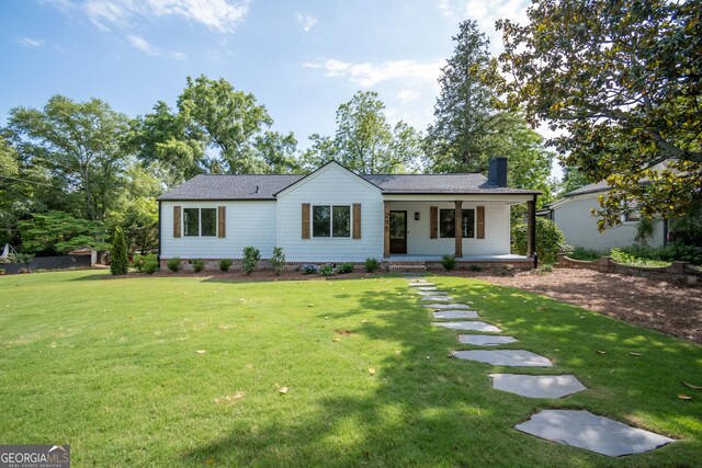 215 Holman Ave, Athens, GA 30606 - ranch-style home with covered porch, a chimney, a front yard, and roof with shingles