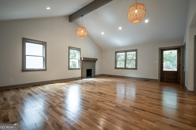 215 Holman Ave, Athens, GA 30606 - unfurnished living room featuring high vaulted ceiling, beam ceiling, a brick fireplace, wood finished floors, and recessed lighting