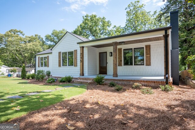 215 Holman Ave, Athens, GA 30606 - ranch-style home featuring a porch, a chimney, and a front yard