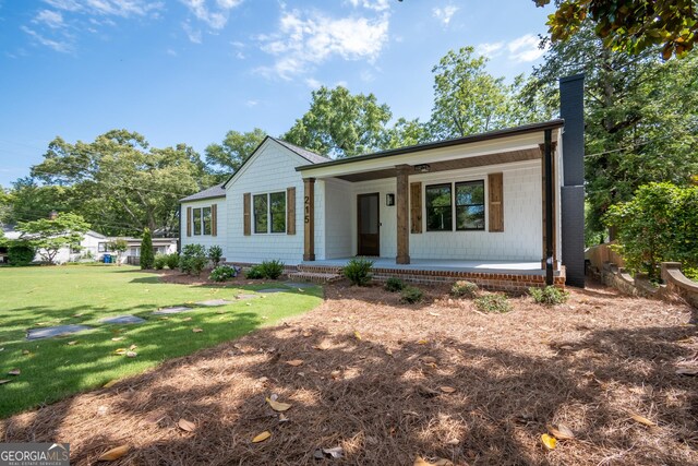 215 Holman Ave, Athens, GA 30606 - view of front of house featuring a porch, a front lawn, and a chimney