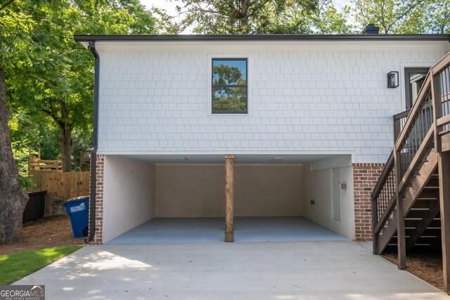 215 Holman Ave, Athens, GA 30606 - view of front facade featuring a carport, stairs, brick siding, and driveway