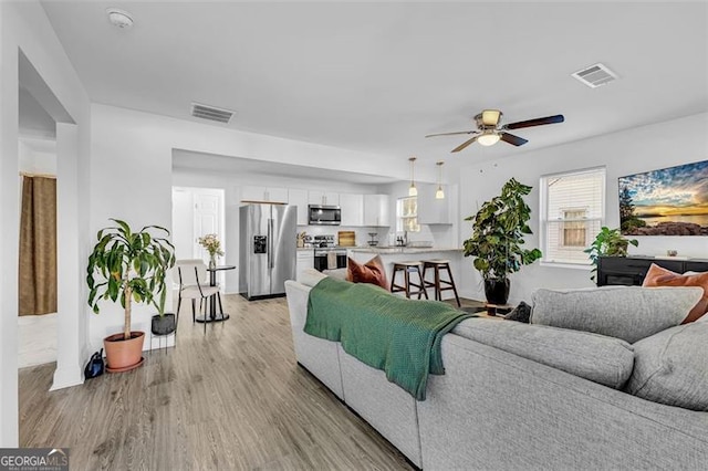 2912 Palm Dr, East Point, GA 30344 - living area with a ceiling fan and light wood-style floors