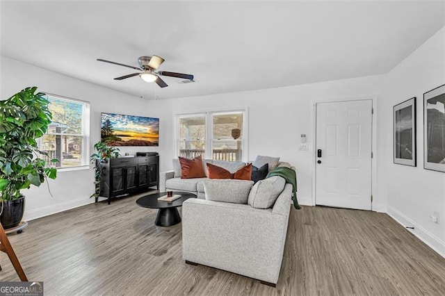 2912 Palm Dr, East Point, GA 30344 - living room featuring ceiling fan, wood finished floors, and healthy amount of natural light
