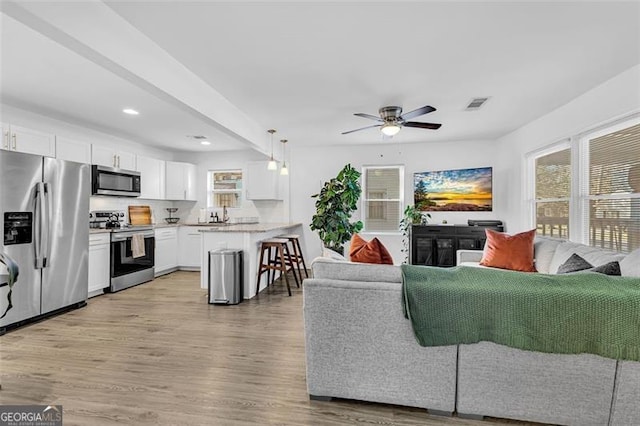 2912 Palm Dr, East Point, GA 30344 - living room featuring plenty of natural light, light wood-style floors, a ceiling fan, and recessed lighting