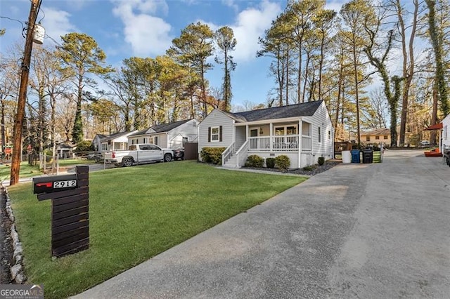 2912 Palm Dr, East Point, GA 30344 - single story home featuring covered porch, a front yard, and a residential view