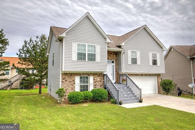 230 Louise Ln, Calhoun, GA 30701 - view of front of house featuring brick siding, driveway, a front lawn, and an attached garage