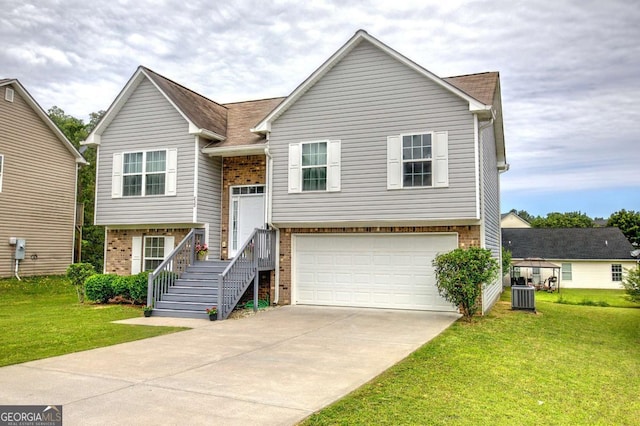 230 Louise Ln, Calhoun, GA 30701 - bi-level home with brick siding, a garage, driveway, and a front yard