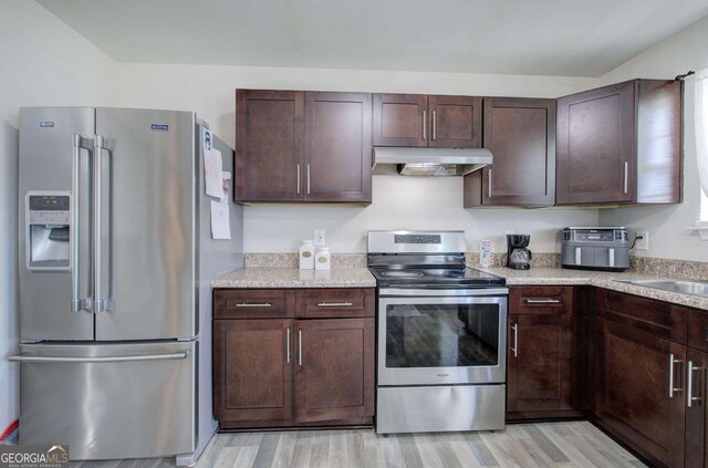 230 Louise Ln, Calhoun, GA 30701 - kitchen featuring stainless steel appliances, under cabinet range hood, light wood finished floors, and dark brown cabinets