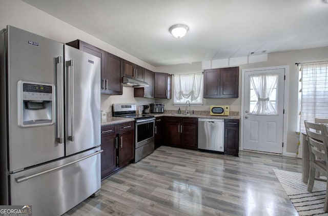 230 Louise Ln, Calhoun, GA 30701 - kitchen featuring appliances with stainless steel finishes, under cabinet range hood, dark brown cabinets, and light wood-style flooring