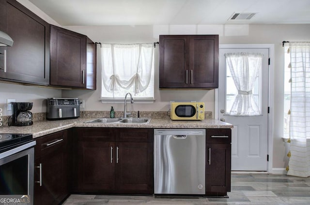230 Louise Ln, Calhoun, GA 30701 - kitchen with appliances with stainless steel finishes, dark brown cabinets, and plenty of natural light